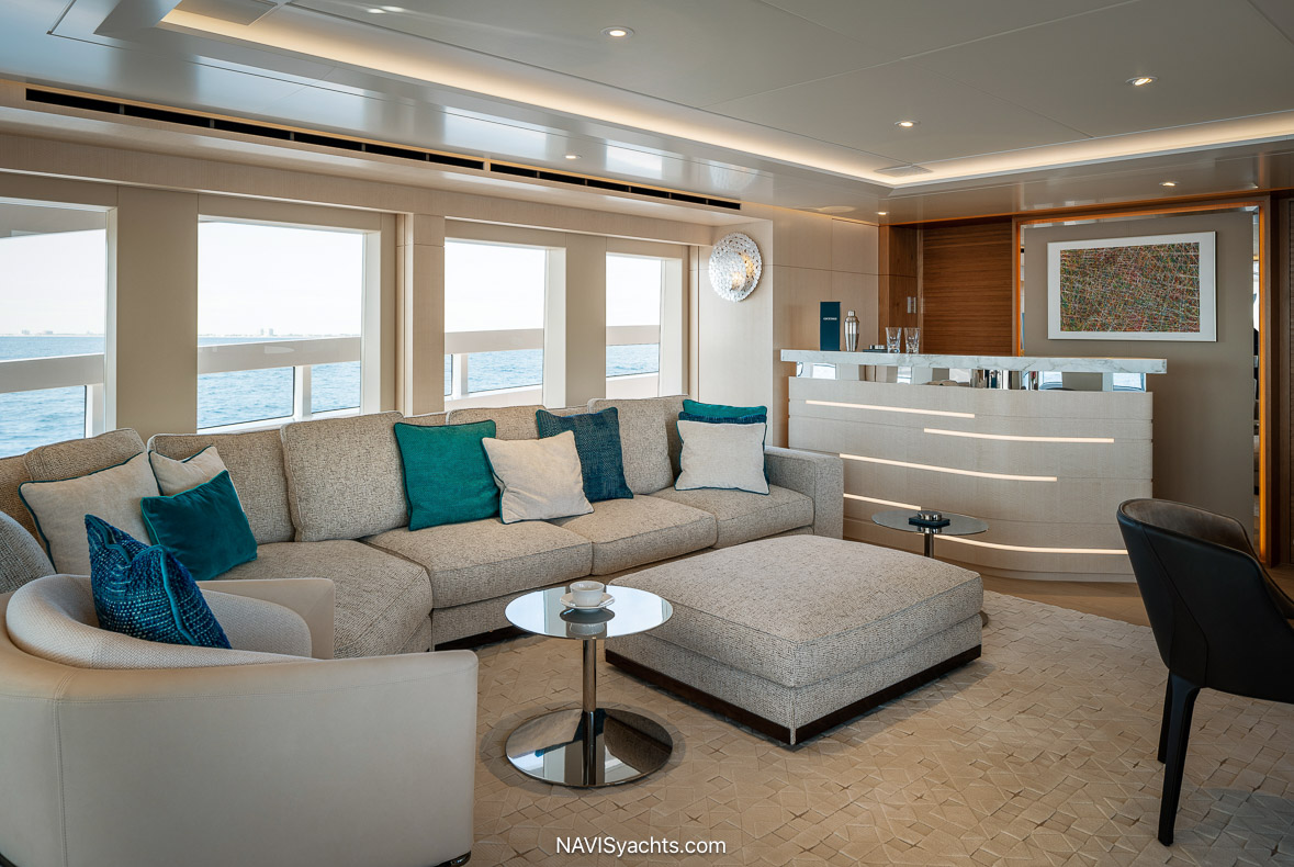 Ocean Z Interior Design - Interior view of Ocean Z highlighting luxurious furnishings and panoramic windows designed by Reymond Langton Design.