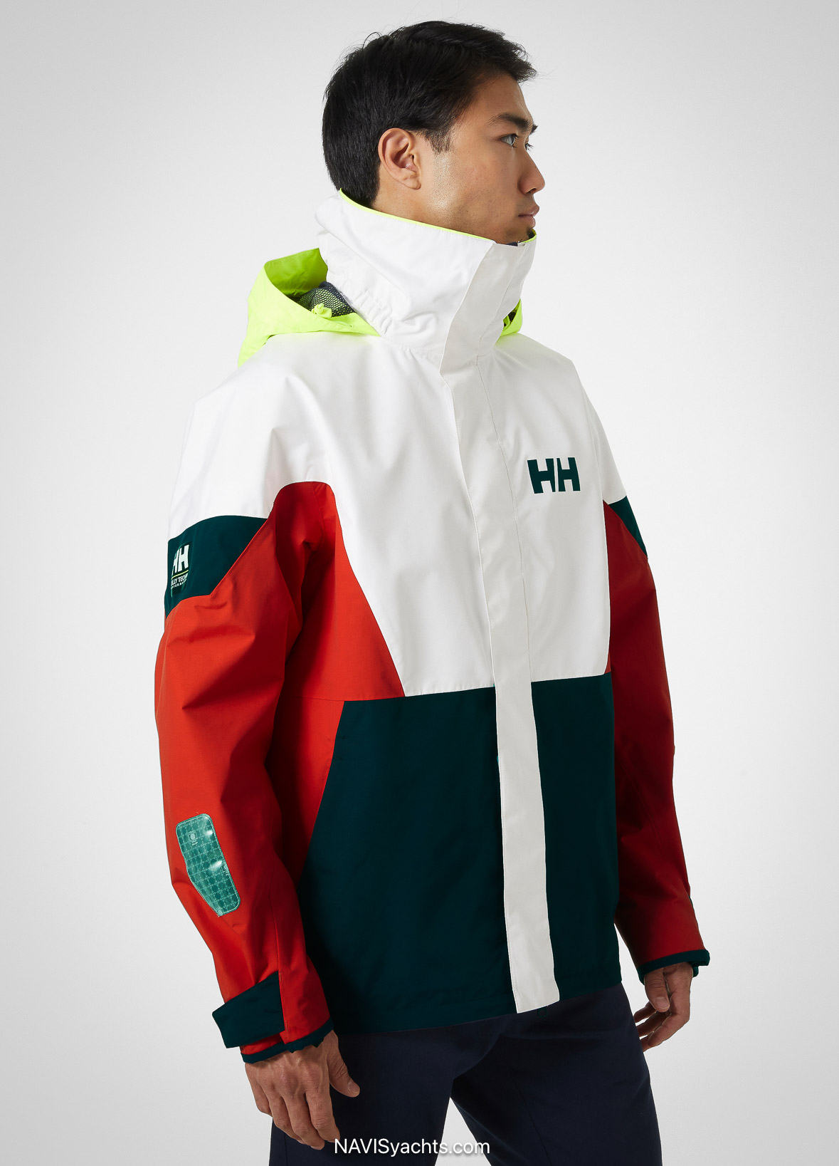 Helly Hansen Men’s Newport Regatta Sailing Jacket in action during a coastal winter sail, showcasing waterproof and windproof performance.