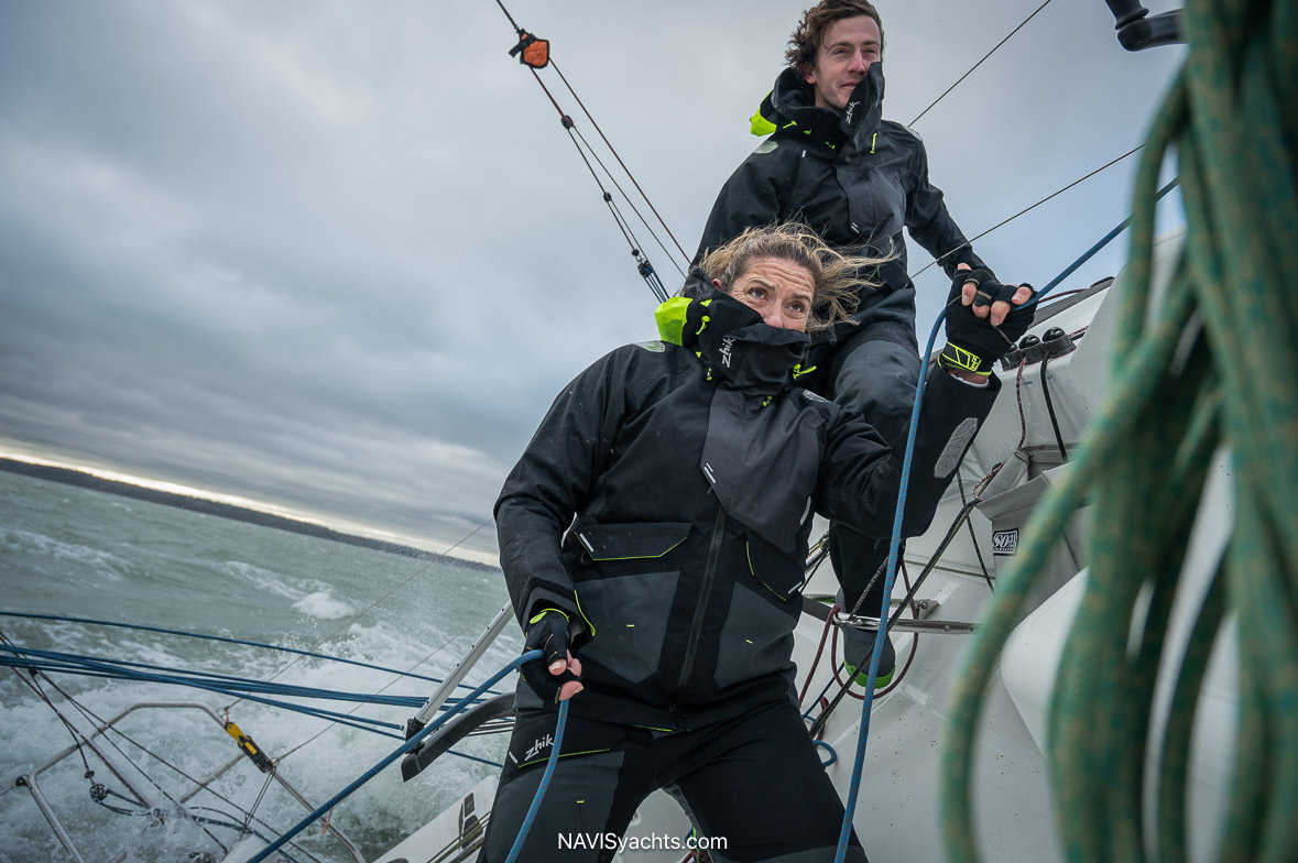 Zhik OFS700 Offshore Sailing Jacket in navy and black, combining waterproof technology and sleek design during a sailing expedition.